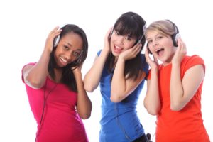 Teenage Girls Singing To Music On Mobile Phones