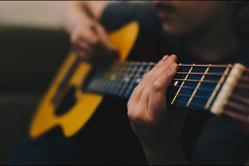 man playing acoustic guitar