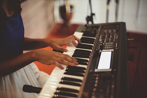 woman playing keyboard